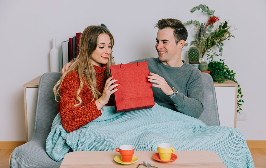 Man gave his wife a book in a red bag as a gift