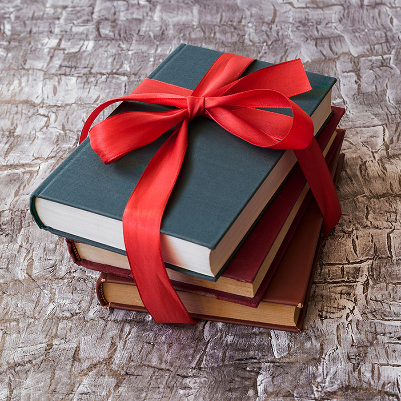 Books with red tape as a gift for book lover